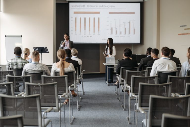 people standing in small auditorium