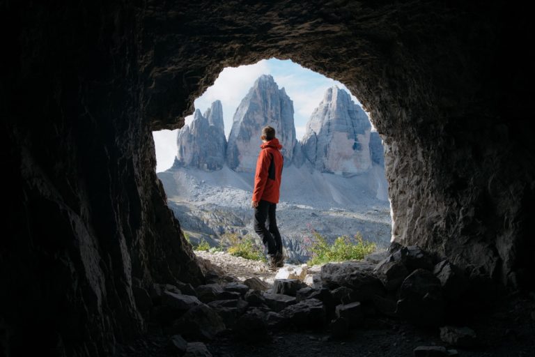 looking out from inside cave with person at mouth